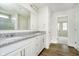 Bathroom with white cabinets, granite countertops, and a framed mirror at 3226 Promenade Way, Brownsburg, IN 46112
