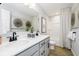 Bathroom featuring a double sink vanity with quartz countertops and modern black faucets at 3226 Promenade Way, Brownsburg, IN 46112