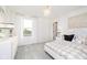 A well-lit bedroom with a charming bed, dresser, and a large window at 3226 Promenade Way, Brownsburg, IN 46112