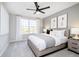 A cozy bedroom featuring a ceiling fan, soft gray walls, and natural light from the window at 3226 Promenade Way, Brownsburg, IN 46112
