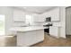 Modern kitchen featuring a central island, stainless steel appliances, and ample cabinet space at 3226 Promenade Way, Brownsburg, IN 46112