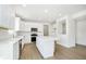 Bright kitchen featuring white cabinetry, stainless steel appliances, subway tile backsplash, and an island at 3226 Promenade Way, Brownsburg, IN 46112
