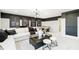 Entertaining living room area featuring a sectional sofa, game table, and decorative wall art at 3226 Promenade Way, Brownsburg, IN 46112