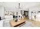 Open-concept living room boasts hardwood floors, a modern chandelier, and a seamless flow to the kitchen at 3226 Promenade Way, Brownsburg, IN 46112