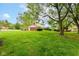 Landscaped backyard with well-maintained lawn and mature trees and bushes at 3325 Broadview Ct, Indianapolis, IN 46227