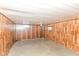 Spacious unfinished basement featuring wood paneling, window, and drop ceiling at 3325 Broadview Ct, Indianapolis, IN 46227