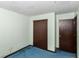 Bedroom featuring a large closet, pale green walls, blue carpet, and doorway at 3325 Broadview Ct, Indianapolis, IN 46227