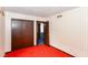 Bedroom featuring a large closet, striped wallpaper, orange carpet, and doorway leading to another room at 3325 Broadview Ct, Indianapolis, IN 46227