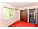 Bedroom featuring a closet, window, striped wallpaper, doorway, and orange carpet at 3325 Broadview Ct, Indianapolis, IN 46227