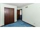 Bedroom featuring a large closet, painted walls, blue carpet, and doorway leading to another room at 3325 Broadview Ct, Indianapolis, IN 46227
