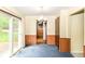 This dining room features neutral walls, blue carpet, and sliding glass doors to the backyard at 3325 Broadview Ct, Indianapolis, IN 46227