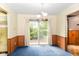 Well-lit dining room showcases neutral walls, blue carpet, and sliding glass doors to the backyard at 3325 Broadview Ct, Indianapolis, IN 46227