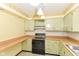 This kitchen offers wooden countertops and green cabinetry, providing a cozy and functional space at 3325 Broadview Ct, Indianapolis, IN 46227
