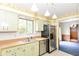This well-lit kitchen features wooden countertops, stainless steel appliances, and green cabinetry at 3325 Broadview Ct, Indianapolis, IN 46227