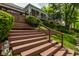 A backyard view shows multiple levels and a long staircase leading up to a raised deck at 3430 Bay Road South Dr, Indianapolis, IN 46240
