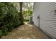 The brick walkway leads to the backyard, with mature trees alongside the home at 3430 Bay Road South Dr, Indianapolis, IN 46240