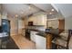 Open kitchen featuring a breakfast bar, black appliances, and tiled floors at 3430 Bay Road South Dr, Indianapolis, IN 46240