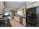 Well-appointed kitchen with black appliances, granite counters, and neutral cabinetry at 3430 Bay Road South Dr, Indianapolis, IN 46240
