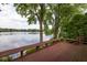 Expansive view of the lake from the deck, surrounded by lush trees and greenery at 3430 Bay Road South Dr, Indianapolis, IN 46240