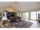 Bright living room with lake views, tile flooring, and a cozy seating area at 3430 Bay Road South Dr, Indianapolis, IN 46240