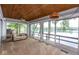 Cozy sunroom featuring stunning lake views, wood ceilings, and ample natural light at 3430 Bay Road South Dr, Indianapolis, IN 46240