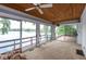 Inviting sunroom with lake views, wood ceiling, and sliding glass doors at 3430 Bay Road South Dr, Indianapolis, IN 46240