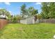 Fenced backyard featuring a detached garage and green space, perfect for outdoor activities at 3614 Guilford Ave, Indianapolis, IN 46205