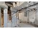 Unfinished basement utility area with concrete floor, laundry sink and exposed duct work at 3614 Guilford Ave, Indianapolis, IN 46205