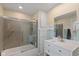 Bathroom with shower-tub combo and vanity with white cabinets at 3614 Guilford Ave, Indianapolis, IN 46205