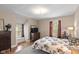 Cozy bedroom with natural light, hardwood floors, and neutral paint at 3614 Guilford Ave, Indianapolis, IN 46205