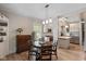 Open dining room with wood floors, neutral paint, and modern chandelier at 3614 Guilford Ave, Indianapolis, IN 46205