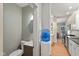 Galley style kitchen with stainless appliances and tile backsplash, plus a nearby half bath at 3614 Guilford Ave, Indianapolis, IN 46205