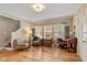 Inviting living room with hardwood floors, staircase, and ample natural light from large windows at 3614 Guilford Ave, Indianapolis, IN 46205