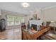Bright living room with hardwood floors, fireplace, classic furnishings, and abundant natural light at 3614 Guilford Ave, Indianapolis, IN 46205