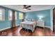 Bedroom with light blue walls, two windows, and ceiling fan at 405 N Drexel Ave, Indianapolis, IN 46201