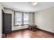Bedroom with hardwood floors, neutral walls, and a window with decorative curtains at 405 N Drexel Ave, Indianapolis, IN 46201