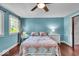 Bedroom with light blue walls, two windows, and ceiling fan at 405 N Drexel Ave, Indianapolis, IN 46201