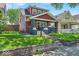 Charming two-story home with mature trees and a well-manicured front lawn creating appealing curb appeal at 405 N Drexel Ave, Indianapolis, IN 46201