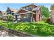 Well-maintained front yard with manicured lawn, landscaping, and a charming two-story home with covered porch at 405 N Drexel Ave, Indianapolis, IN 46201