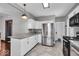 A modern kitchen features stainless steel appliances, granite countertops, and tiled floors at 405 N Drexel Ave, Indianapolis, IN 46201