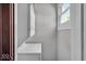 A laundry room with stacked washer and dryer, bright window, and fresh paint at 405 N Drexel Ave, Indianapolis, IN 46201