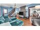Spacious living room with hardwood floors, a comfortable sofa, and access to the kitchen and staircase at 405 N Drexel Ave, Indianapolis, IN 46201