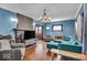 Bright living room with hardwood floors, a decorative fireplace, and comfortable seating at 405 N Drexel Ave, Indianapolis, IN 46201