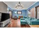 Cozy living room features hardwood floors, a large sofa, and a decorative chandelier at 405 N Drexel Ave, Indianapolis, IN 46201