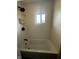 Bright bathroom showcasing a white tub, shower, and a window allowing for natural light at 426 St Paul St, Indianapolis, IN 46201