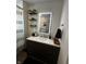 Modern bathroom features floating shelves, an illuminated mirror, and a stylish vanity with dark wood cabinets at 426 St Paul St, Indianapolis, IN 46201
