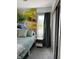 Serene bedroom with a vibrant forest mural, complemented by natural light, adding warmth and character to the space at 426 St Paul St, Indianapolis, IN 46201