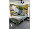 Relaxing bedroom with a nature-themed mural, creating a calming ambiance with its green hues and soft lighting at 426 St Paul St, Indianapolis, IN 46201