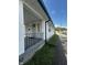 Charming front porch with a black railing, stone foundation, and a clear view of the street at 426 St Paul St, Indianapolis, IN 46201