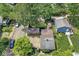 An aerial view of the property showcasing its backyard, detached garage, and surrounding greenery at 5002 Broadway St, Indianapolis, IN 46205